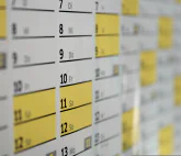 Angled photo of a portion of a calendar with yellow highlighted dates.