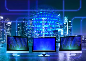 An illustration of computer monitors with binary digits floating behind them\nin a globe formation. In the background is the late evening skyline of a modern metropolis.\n